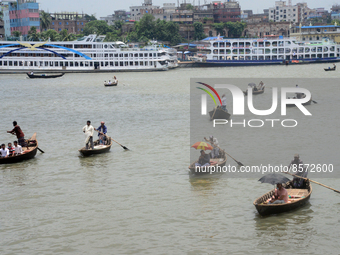 People cross the busy Buriganga river by boat during high temperature weather in Dhaka, Bangladesh, on July 22, 2022 (