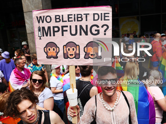 A man holds a banner reading 'Where is the vaccination?' during the Christopher Street Day demonstration in Berlin, Germany on July 23, 2022...