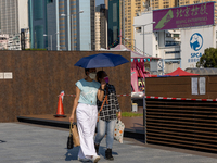 People shelter from the sun under umbrellas as a heatwave is hitting the norther hemisphere, in Hong Kong Hong Kong, S.A.R. Hong Kong, July...