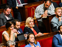 Rassemblement National deputy Marine Le Pen. (right) speaks with Sébastien Chenu (left). Continuation of the discussion of the amending fina...