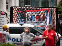 A truck playing Fox News' 2020 announcement that Biden won the presidential election drives behind Trump supporters gathered outside Trump's...