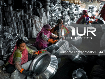 Women work inside a kitchen utensils factory at Shyampur in Dhaka, Bangladesh on July 4, 2022.  (