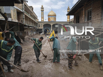 Workers clear mud at Imamzadeh Davood holy shrine after flash floods in the northwestern part of Tehran on July 29, 2022.  (