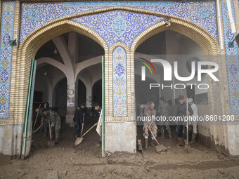 Members of the Islamic Revolutionary Guard Corps (IRGC) clear mud at Imamzadeh Davood holy shrine after flash floods in the northwestern par...