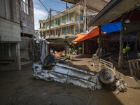 A view of a vehicle which is damaged caused of flash flooding is pictured in the flooded village of Imamzadeh Davood in the northwestern par...