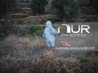 A wet baby’s jumpsuit is hung to dry on a fence along the shoreline on Lesbos, Greece, on September 27, 2015.  (