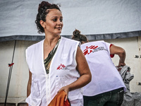 A member of Médecins Sans Frontières (MSF) help migrants in the Greek Island of Kos, on October 21, 2015. Both the local community and large...