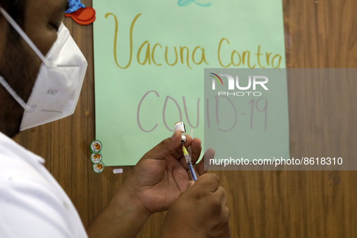 A health worker prepares a dose of Pfizer during the pediatric vaccination campaign for children under 8 years of age   against Covid19 at t...