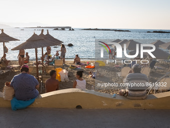 Tourists and locals are enjoy their time at the beach of Nea Chora while high temperatures in Chania, Crete Island, Greece on July 2, 2022....
