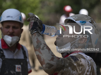 A member of the Iranian Red Crescent Society (IRCC) drinks water as he prepares to search for a body of a flood victim, five days after a su...