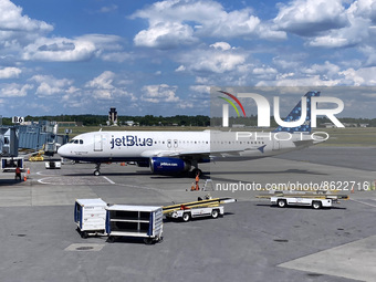 A JetBlue aircraft is seen at a Baltimore/Washington International Thurgood Marshall Airport gate as construction on the new Concourse A Ext...