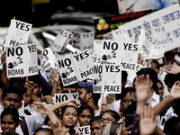 Students carry banners depicting slogans like 'No More Hiroshima' and 'We want to grow, not to blow up' and placards, banners, flags depicti...