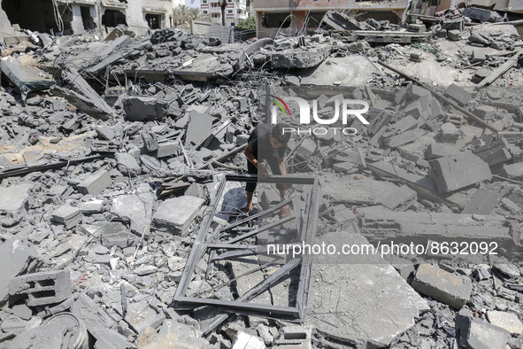 A Palestinian boy on the rubble of house destroyed by Israeli airstrikes, in Gaza City, on 06 August 2022. 