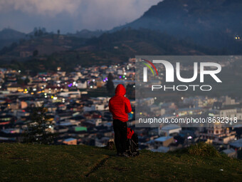 A tourist enjoys a view of the Dieng mountain area in Banjarnegara, Central Java province, Indonesia, on August 6, 2022. (