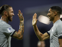 Achraf Hakimi of PSG celebrates with Sergio Ramos after scoring his sides first goal during the Ligue 1 match between Clermont Foot and Pari...