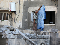 A Palestinian man inspects damage outside a residential building in Gaza City August 8, 2022, following a cease fire proposed by Egypt betwe...