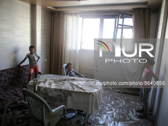 Palestinian children check the damage inside their apartment in Gaza city early on August 8, 2022, following a cease fire between Israel and...