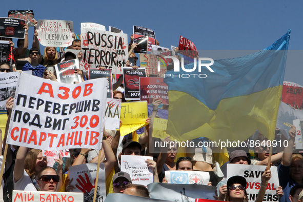 DNIPRO, UKRAINE - AUGUST 07, 2022 - People hold flags and placards during the action in support of the Azovstal POWs at the Festival Pier to...
