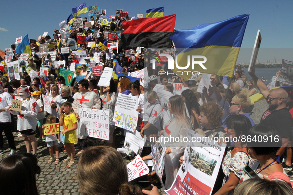 DNIPRO, UKRAINE - AUGUST 07, 2022 - People hold flags and placards during the action in support of the Azovstal POWs at the Festival Pier to...