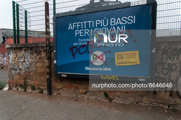 Billboards advertising the Democratic Party for the 25 September 2022 general election, vandalised with the words 'Porci' (Pigs) in Via del...