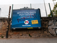 Billboards advertising the Democratic Party for the 25 September 2022 general election, vandalised with the words 'Porci' (Pigs) in Via del...