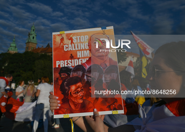 A protester holding a poster with an image of the  Belarusian leader with words 'Stop Calling Him President'.
Members of the local Belarusia...