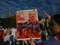 A protester holding a poster with an image of the  Belarusian leader with words 'Stop Calling Him President'.Members of the local Belarusia...