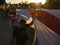 Protesters carry a geant historical flag of Belarus (1918, 1991-1995).Members of the local Belarusian and Ukrainian diaspora supported by l...
