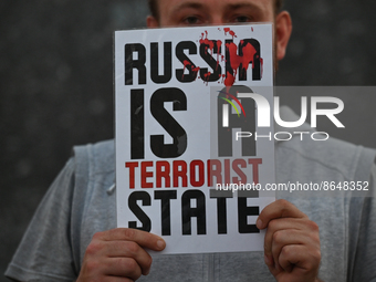 A protester holding a poster with words 'Rusia Is A Terrorist State'.
Members of the local Belarusian and Ukrainian diaspora supported by lo...