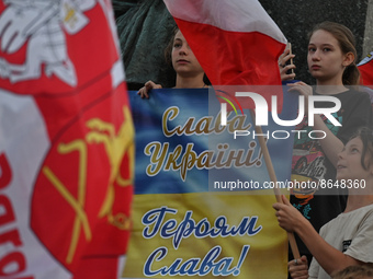 Young protesters holding a banner with words 'Glory To Ukraine'.Members of the local Belarusian and Ukrainian diaspora supported by local C...