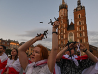 Protesters break symbolic paper prison bars representing the Belarusian population in prisons and the lack of freedom in Belarus.
Members of...