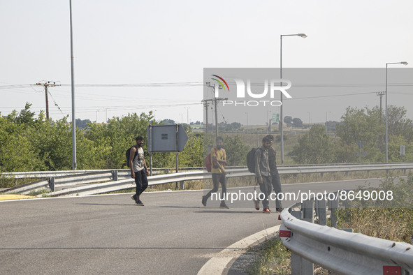 A group of young asylum seekers from Pakistan as seen walking on the road next to the cars near the city of Komotini next to Egnatia highway...