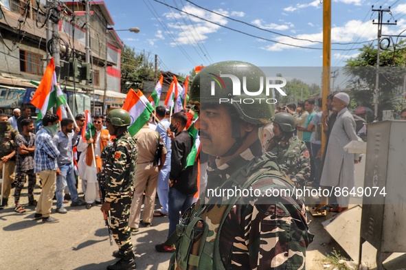 A CRPF Trooper stands alert as BJP workers celebrate Tiranga Rally. BJP workers held Tri-Color (Tiranga) Rally in Baramulla Jammu and Kashmi...
