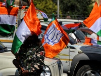 A CRPF Trooper stands alert near a BJP Flag and Indian National Flag. BJP workers held Tri-Color (Tiranga) Rally in Baramulla Jammu and Kash...