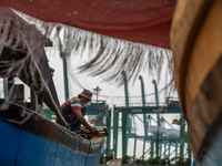 Dockyard workers carry on maintenance works of a ship in Jakarta on 17 August 2022.(