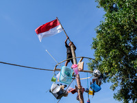 A child participated doing greased pole climbing competition during the 77th Indonesia Independence Day celebration, on 17 August 2022, in B...