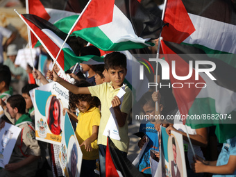 Palestinians carrying Palestinian flags and pictures of children who were killed during the latest round of conflict between Israel and Pale...