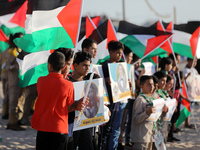Palestinians carrying Palestinian flags and pictures of children who were killed during the latest round of conflict between Israel and Pale...