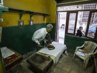 Egyptian worker Ahmed El-Gon, 67 years old, heats a traditional leg-iron at his shop in Darasa district near Old Cairo, Egypt, 17 August 202...