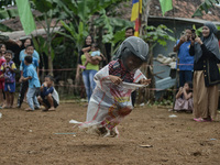 A child participated sack race game wearing helmet competition to commemorate Indonesia's 77th Independence Day in Bogor, West Java, Indones...