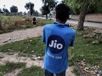 An employee of Jio Company Installs Fibre on the outskirts of Sopore District Baramulla Jammu and Kashmir India on the 18 August 2022. Relia...