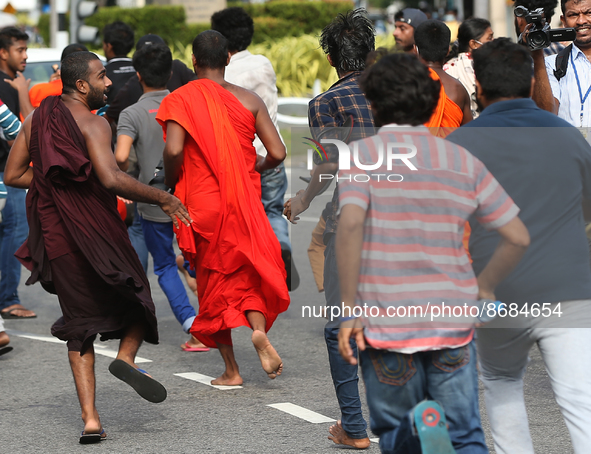 Protesters run as Sri Lankan Police disperse Protesters during the Inter-University Student Federation protest against the government of Pre...