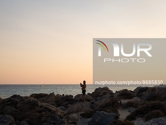 A man enjoy the sunset at Cedar Forest (Kedrodasos) beach in Chania, Crete Island, Greece on August 18, 2022. (