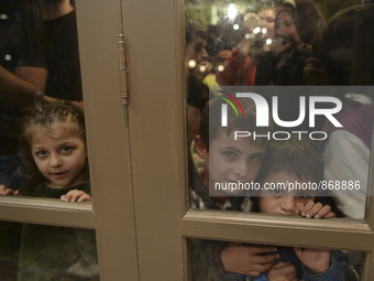 Children-refugees awaiting to enter to the Aspa Boomerang Restaurant, as the owner Michael Pastrikos, helped by his family members, his staf...