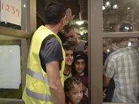 Happy children-refugees on their way to enter to the Aspa Boomerang Restaurant, as the owner Michael Pastrikos, helped by his family members...