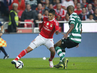 Benfica's forward Raul Jimenez (L) vies for the ball with Sporting's defender Naldo (R)  during the Portuguese League  football match betwee...