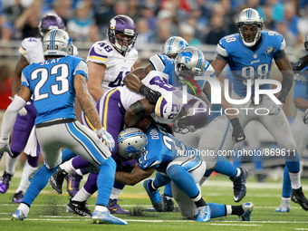 Minnesota Vikings running back Adrian Peterson (28) gets tackled by Detroit Lions free safety Glover Quin (27) during the second half of an...