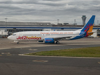 Jet2 Boeing 737-800 aircraft as seen in Edinburgh Airport in front of the terminal and the control tower. The Jet2.com Boeing 737 passenger...