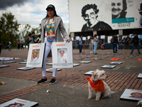 A relative carries the photos of their family members victim of enforced disappearances during the framework of the International Day of the...