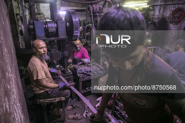 Climate migrant people work unhealthy and risky environment in a Door Locker making factory factory at Dhaka, Bangladesh on August 30, 2022....